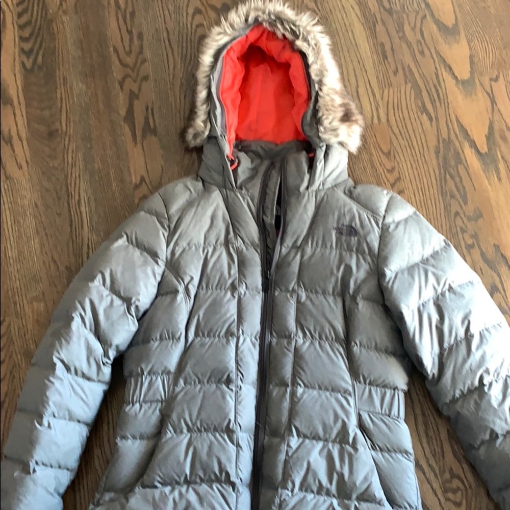 North face grey jacket with orangey-pink lining.